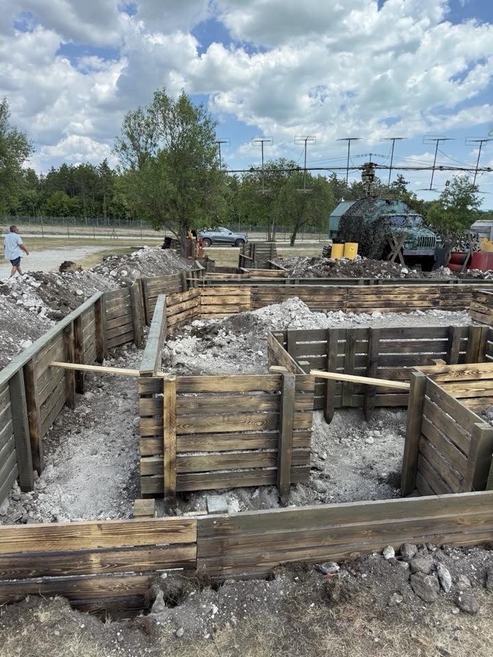 Timber-lined trenches under construction in an outdoor area.